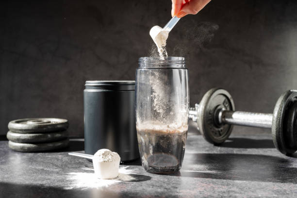 protein shake and chocolate protein powder in a scoop, sports nutrition.